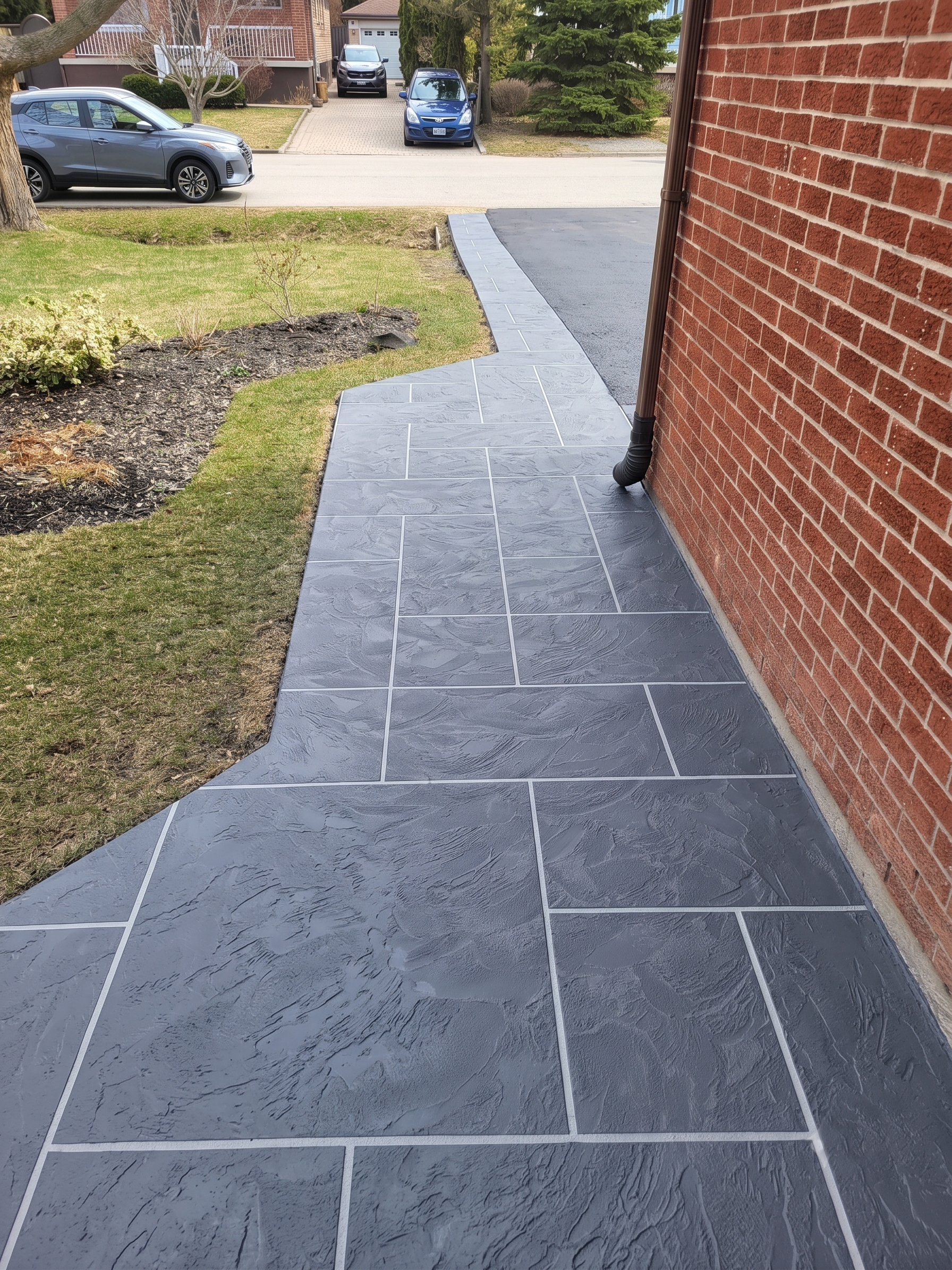 Walkway and driveway edge after grey Jewelstone resurfacing